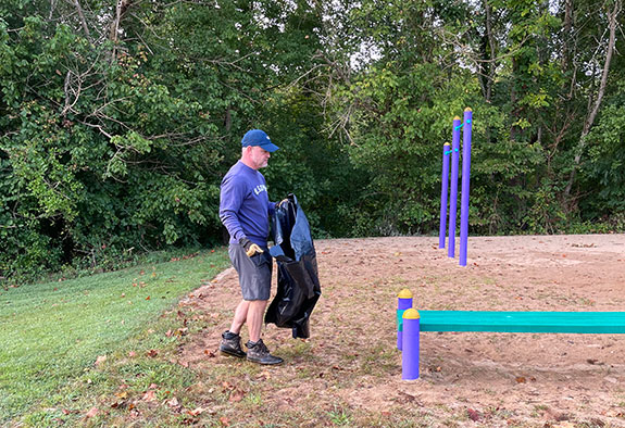 Rotarian Chance cleaning up around equipment