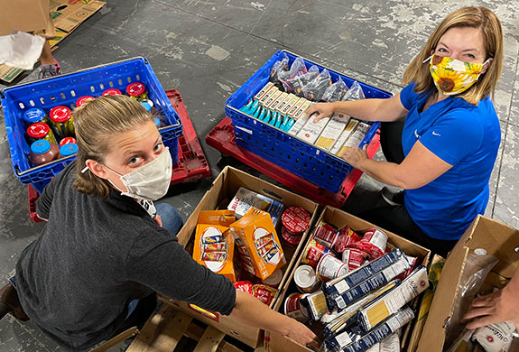 Rotarians Catherine and Shaunna prepare for food distribution