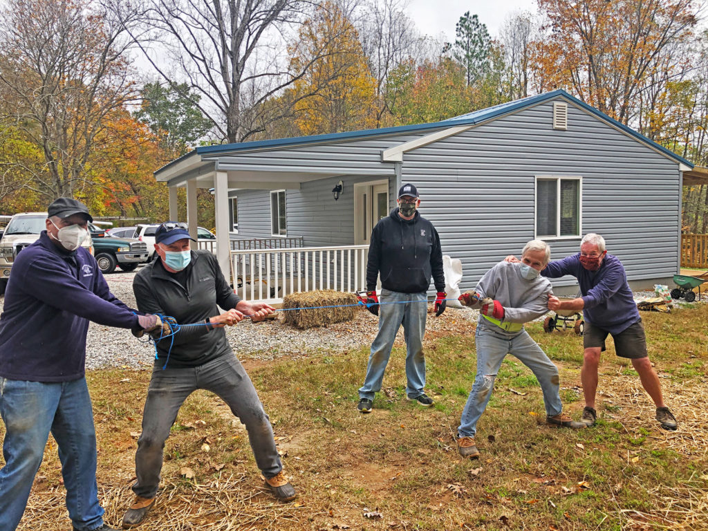 Rotarians clown around after working on landscaping